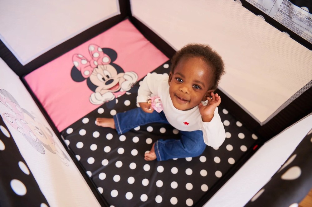 Disney Baby 3D Ultra Baby Play Yard with Bassinet and Toy Bar. Peeking Minnie